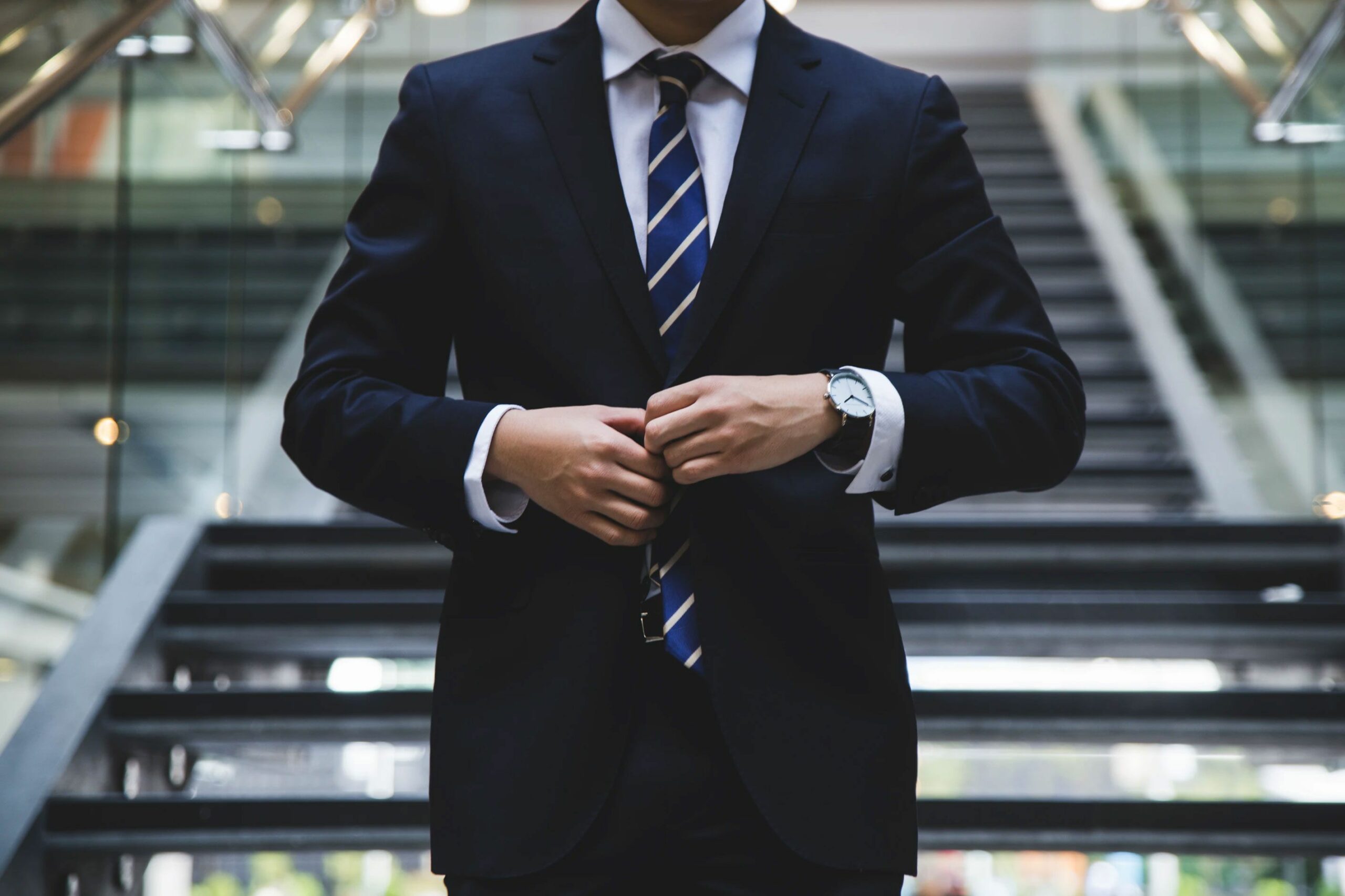 Man Buttoning Up Suit Jacket 1