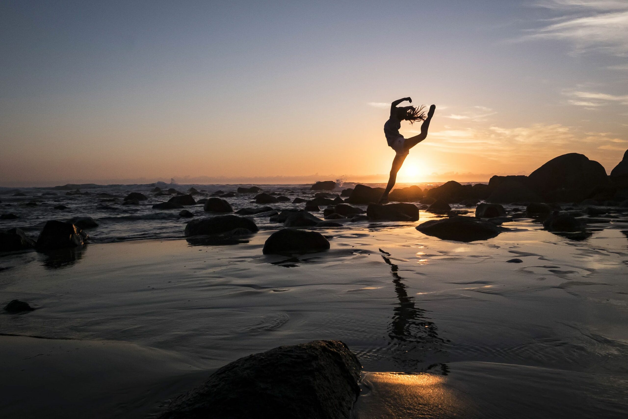 Woman Doing Yoga at the Beach Woman doing Yoga at the Beach